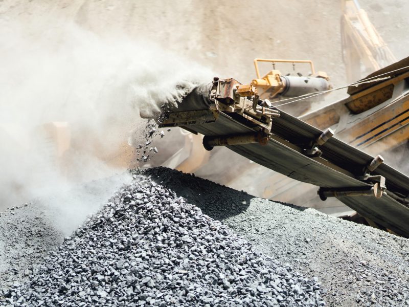 Details of stone breaker at industrial rock and marble quarry. Granite rocks crusher