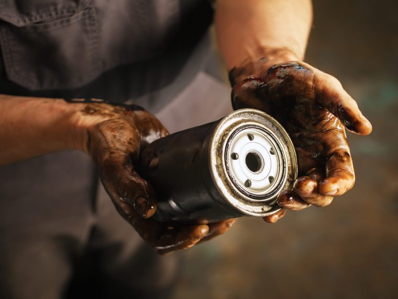 Auto mechanic with dirty hands and oil filter. Service maintenance. Auto mechanic with dirty hands and oil filter. Service maintenance.