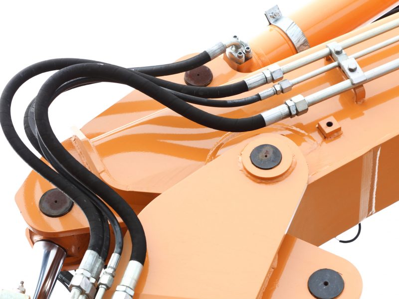 Detail of hydraulic bulldozer excavator arm construction machinery white background